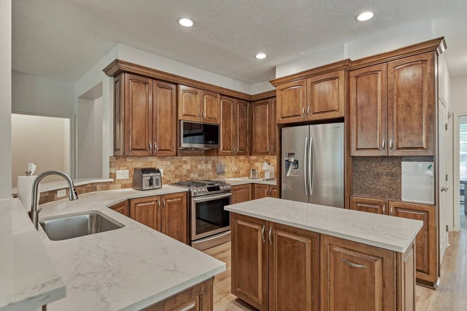 Prep favorite dishes surrounded by granite counters and stainless steel.