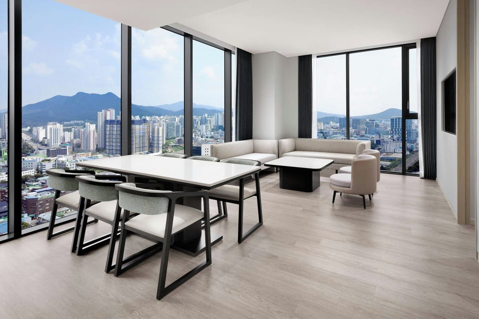 Suite, 1 King Bed, City View, Corner | Living room | 65-inch LED TV with cable channels, heated floors
