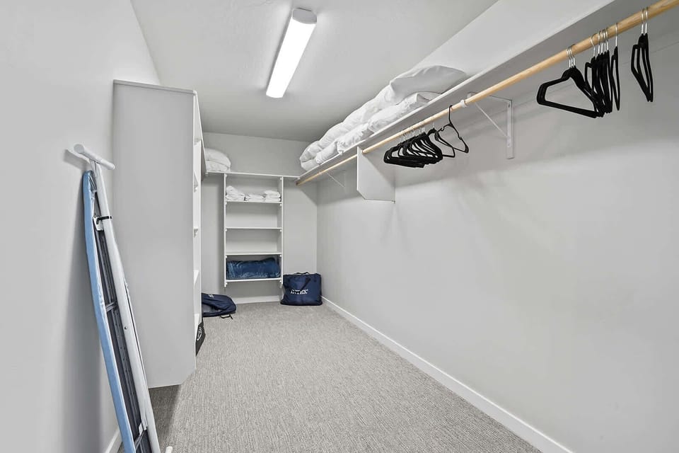 Master Closet with 2 air mattresses, pack n plays, ironing board, and extra pillows