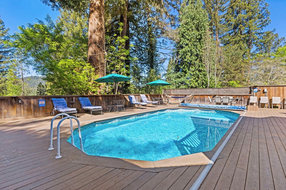 Enjoy the deck surrounded by towering redwoods, with a hot tub and pool for relaxation. Dine alfresco or catch up on work at the outdoor table, all under the natural shade of the trees.
