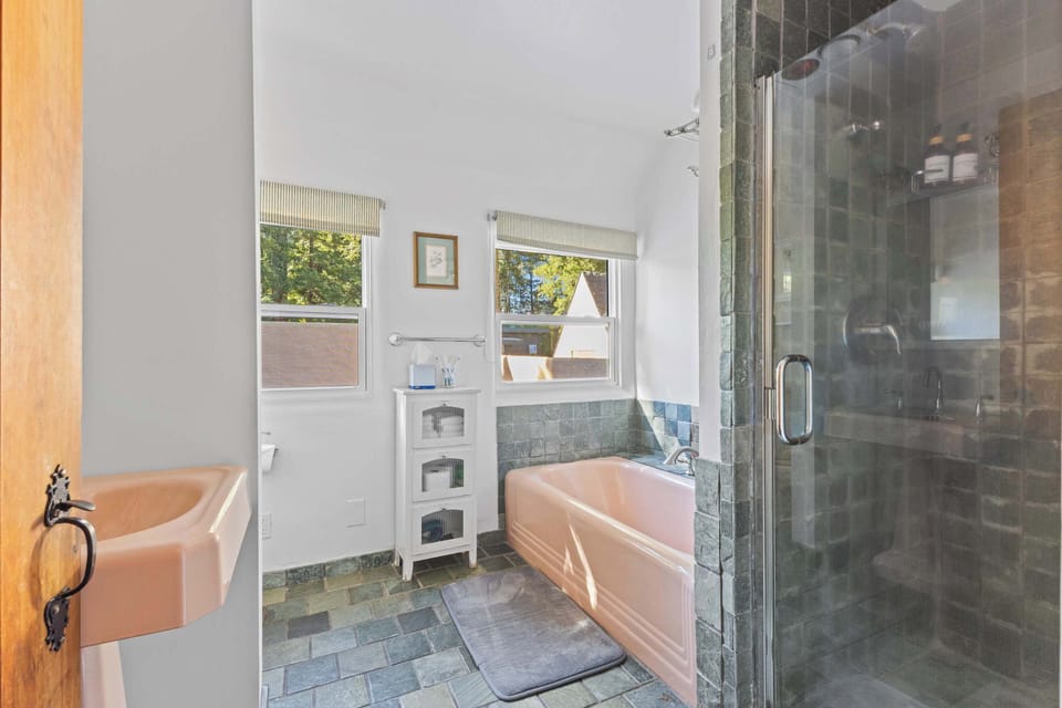 The shared upstairs bathroom includes a bathtub, shower, toilet, and an adorable vanity.