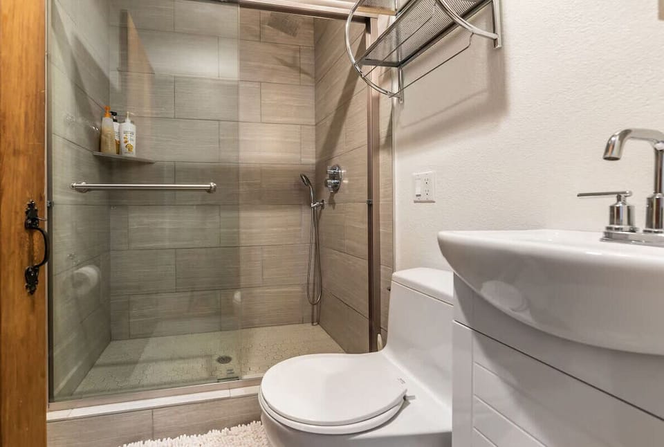 Conveniently located off the kitchen and adjacent to the Butler Room, this bathroom offers a shower, sink, and toilet.
