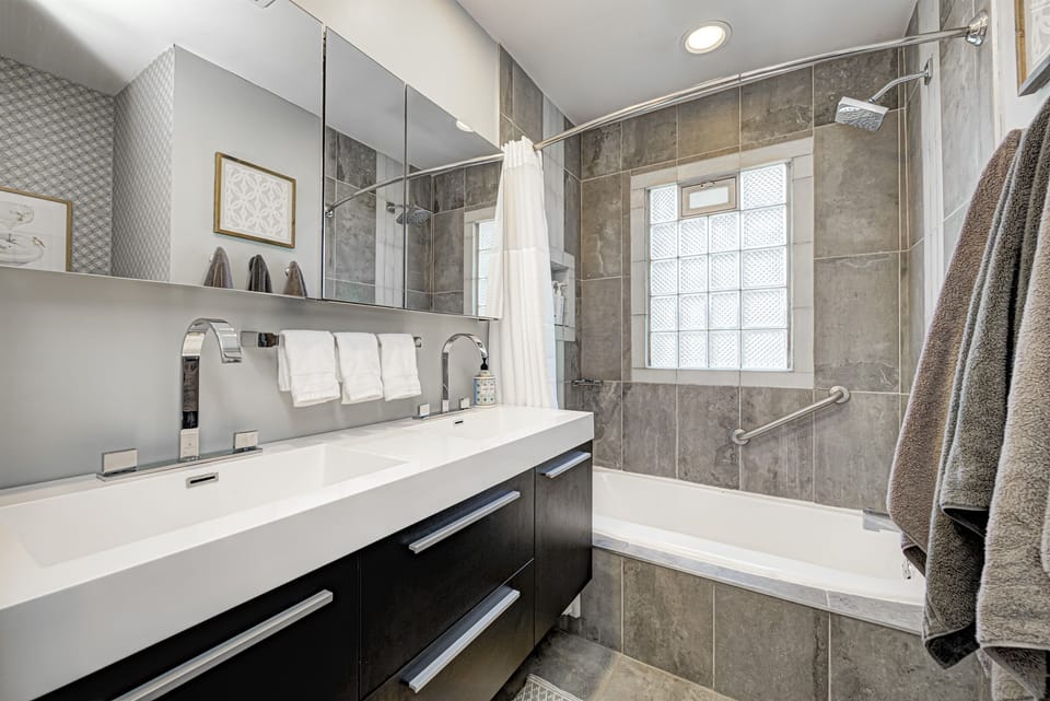 The main-floor bathroom offers two sinks and a shower and tub combination.