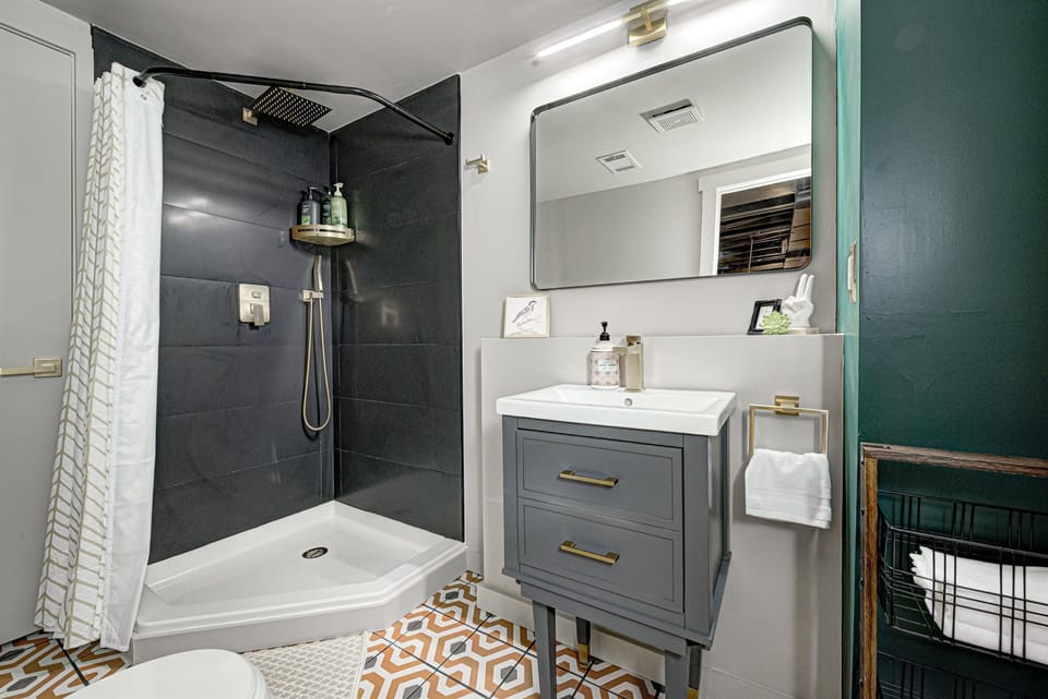 A full bathroom with a shower on the basement level.