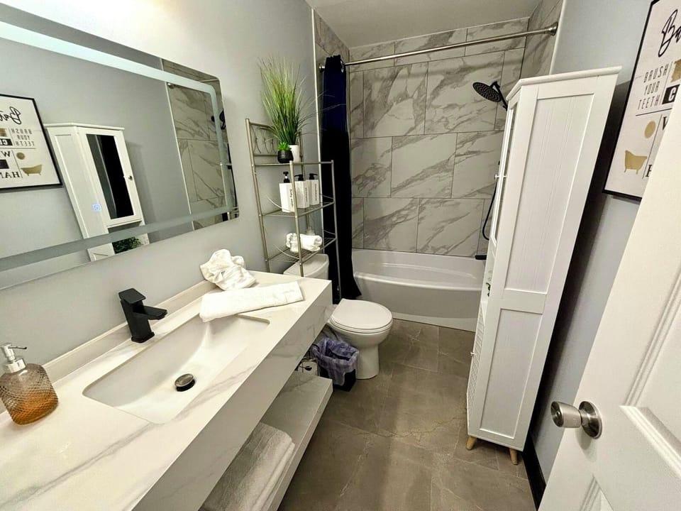 Elegant Bathroom: Contemporary design with marble accents, modern fixtures, and ample storage space.