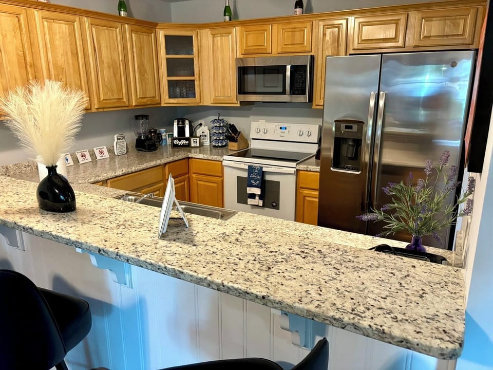 Kitchen: Stylish design with gleaming granite counters and modern appliances for culinary adventures!