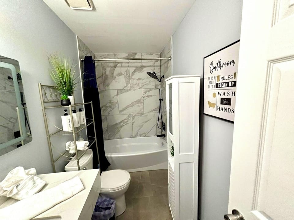 Bathroom Oasis: Elegant marble tiles, modern fixtures, and charming decor for a refreshing retreat!