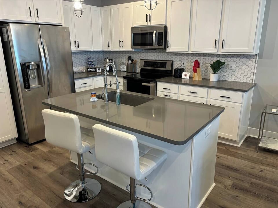 Gourmet Kitchen: Sleek countertops, stainless steel appliances, and stylish bar seating await your culinary adventures!