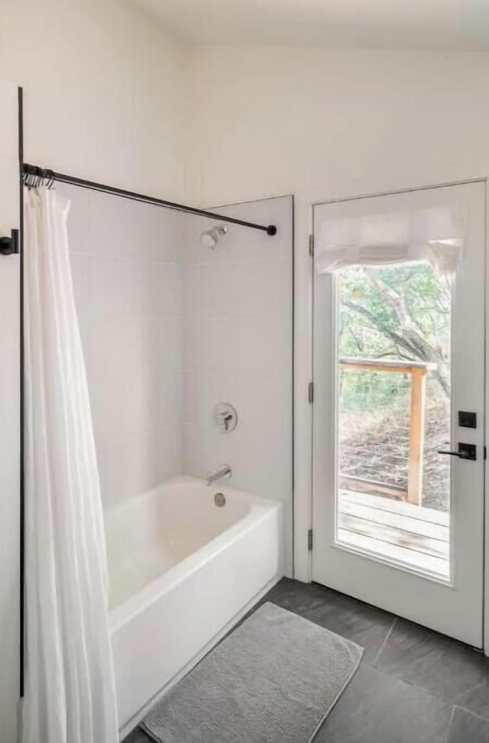 Bathroom with balcony looking into the forest