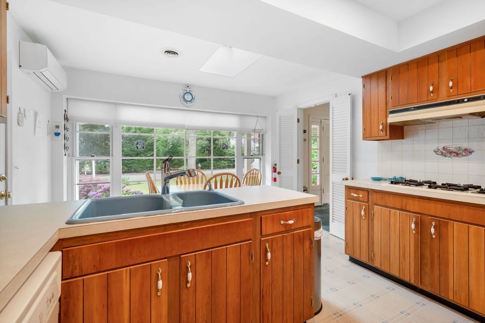 Overlook another wall of glass in the home from the sink or nearby eat-in area of the kitchen - 38 Monomoyic Way Chatham Cape Cod-Poppy's Place-NEVR