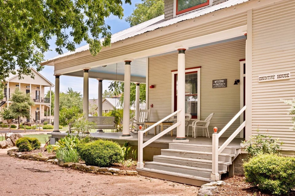 The Country House's historic charm is highlighted by its classic Greek revival architecture and inviting dormers.