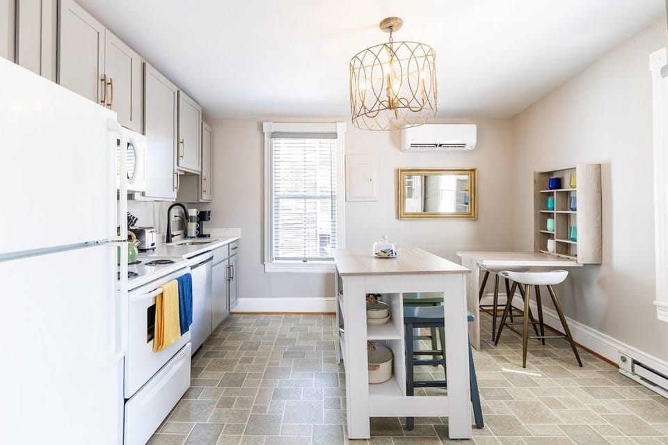 The kitchen island doubles as a breakfast bar counter with seating for 2 with seating for 2 more at the table.