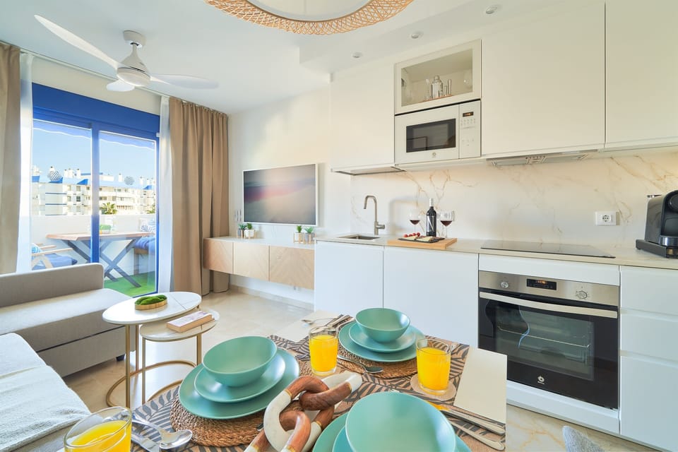 Living room with access to kitchenette and dining area.