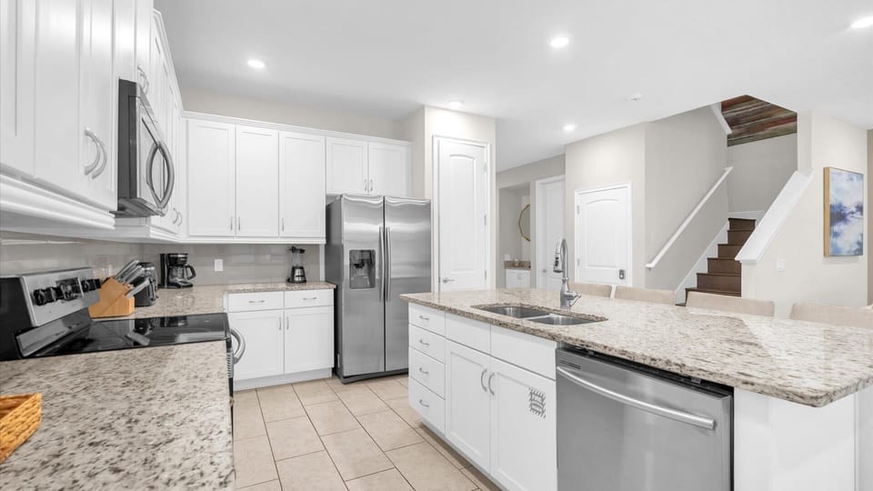 Spacious and modern kitchen with granite countertops and stainless steel appliances, perfect for cooking and entertaining.