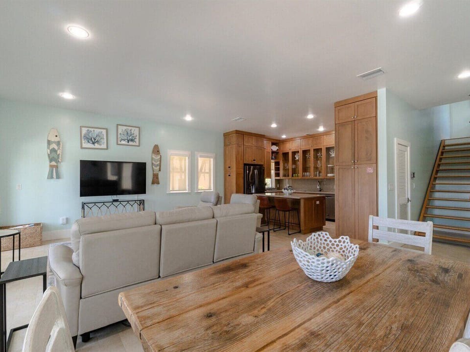 Spacious open-concept living room connecting seamlessly to the dining area and kitchen.