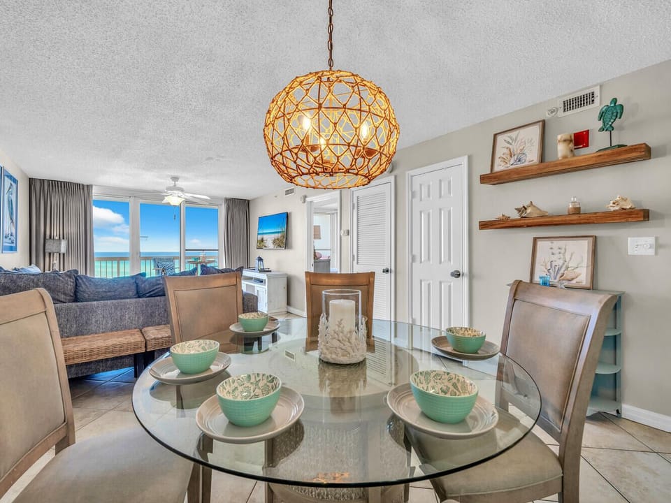 Your elegant dining space features a glass table set for memorable meals, while the stunning ocean view creates the perfect coastal dining atmosphere.