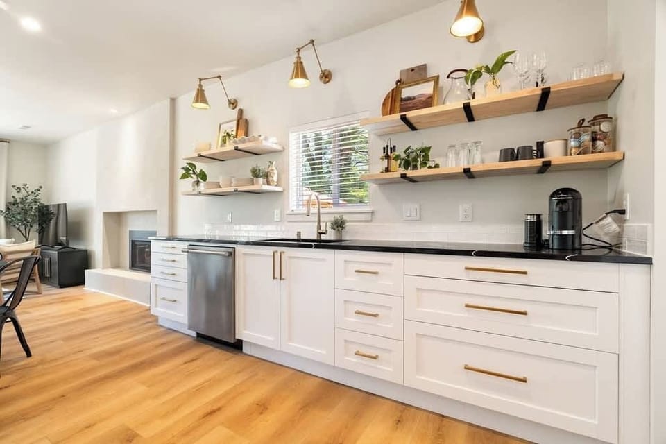 The kitchen boasts sleek cabinets that offer ample storage space and are complemented by stunning granite countertops. 