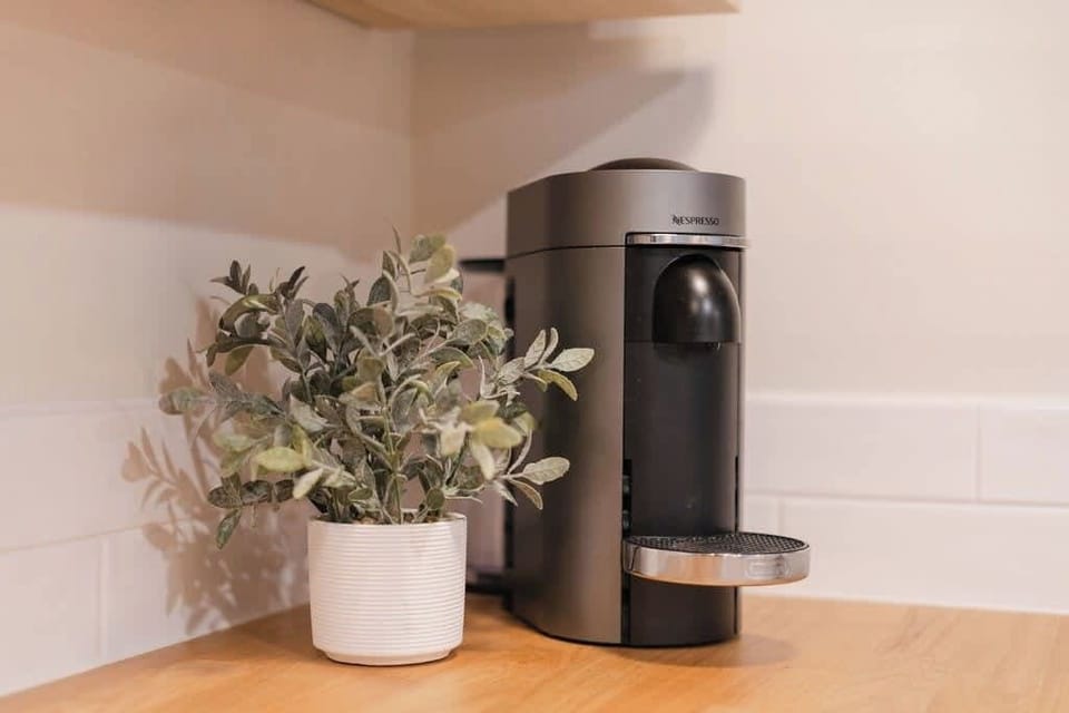 
The kitchen features a Nespresso machine, perfect for brewing rich, barista-quality coffee at the touch of a button. Easy to use and versatile, it allows you to enjoy a variety of coffee drinks, from espresso shots to creamy lattes, right at home.