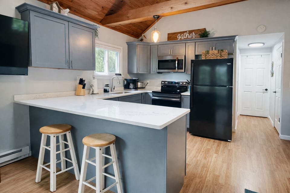 Bright, modern kitchen with quartz countertops and everything you need to cook.