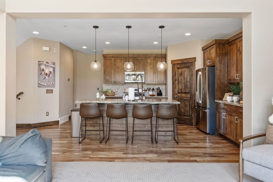 The kitchen is right next to the living room and features a breakfast counter, perfect for casual meals and entertaining | Noah's Retreat, Park City, Utah | Voyax Luxury Vacation Rentals