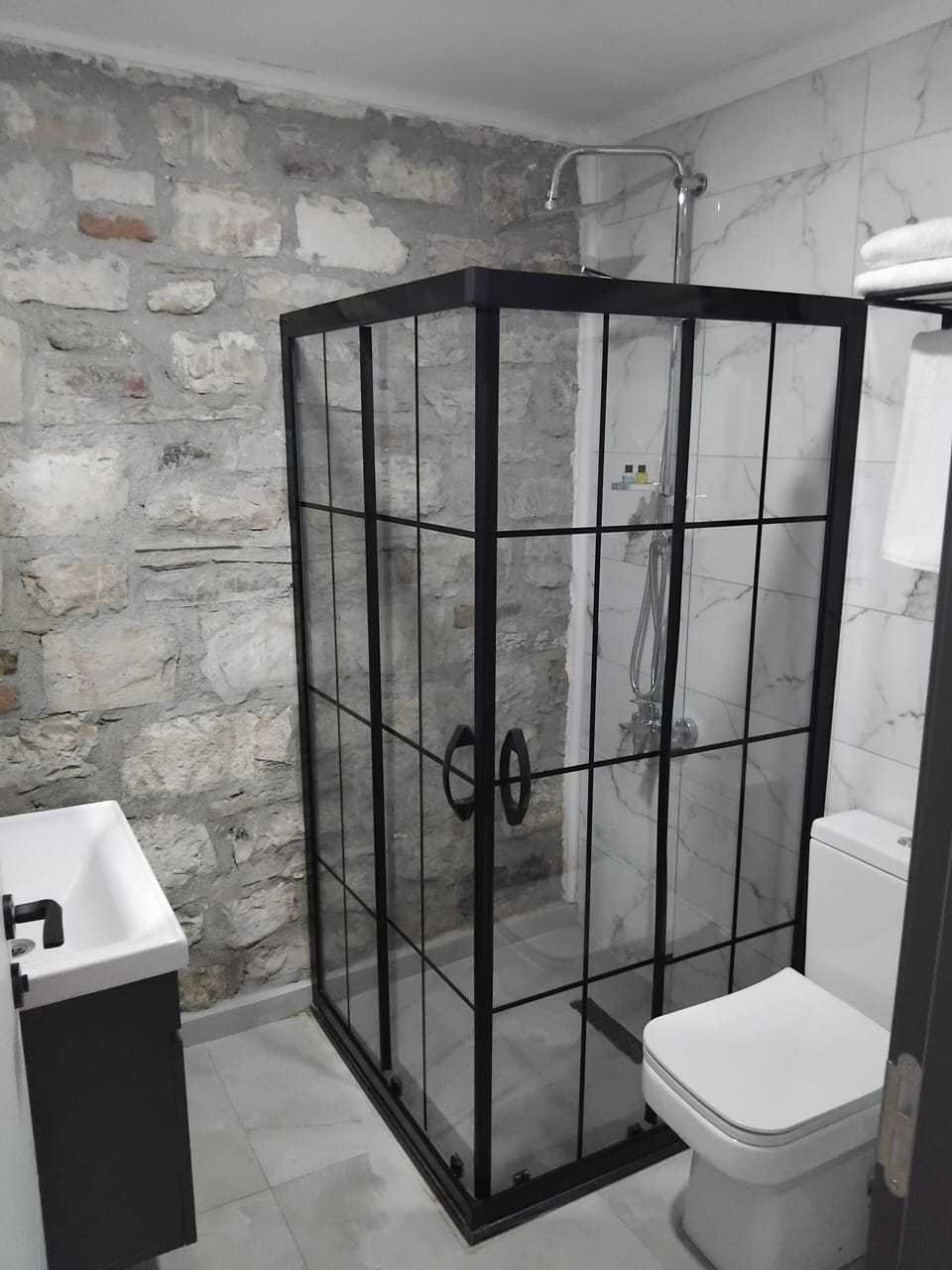Shower, hair dryer, slippers, towels