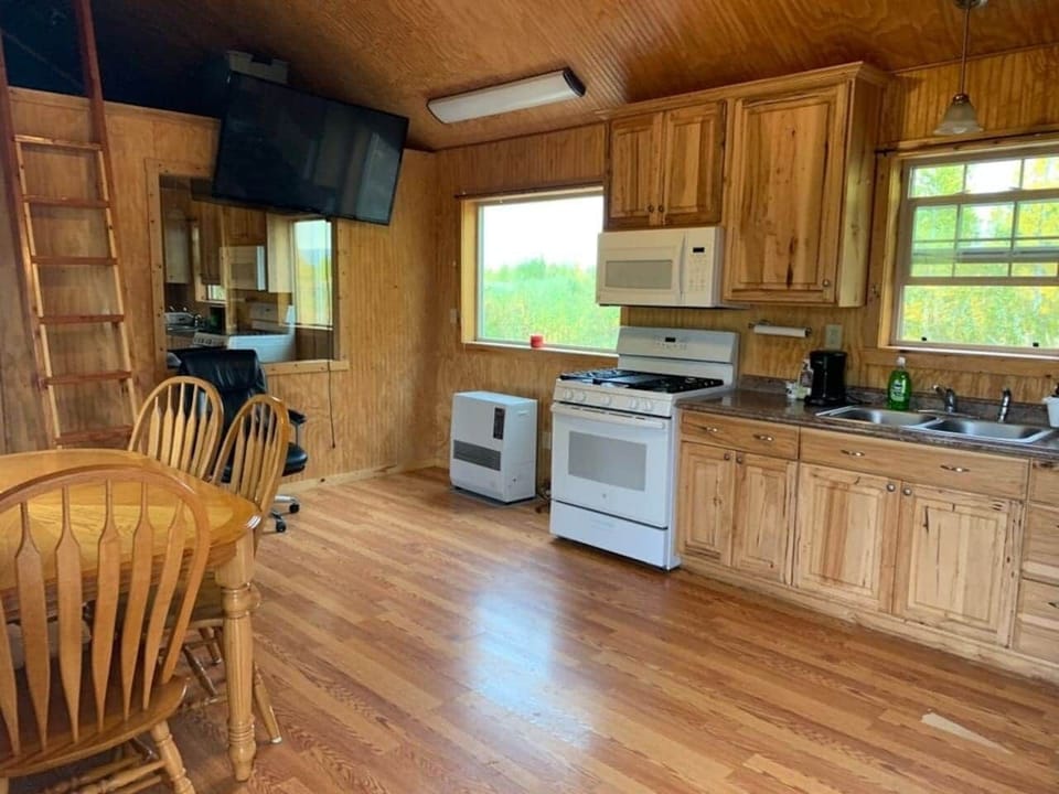 Kitchen table with seating for four.  Full kitchen appliances