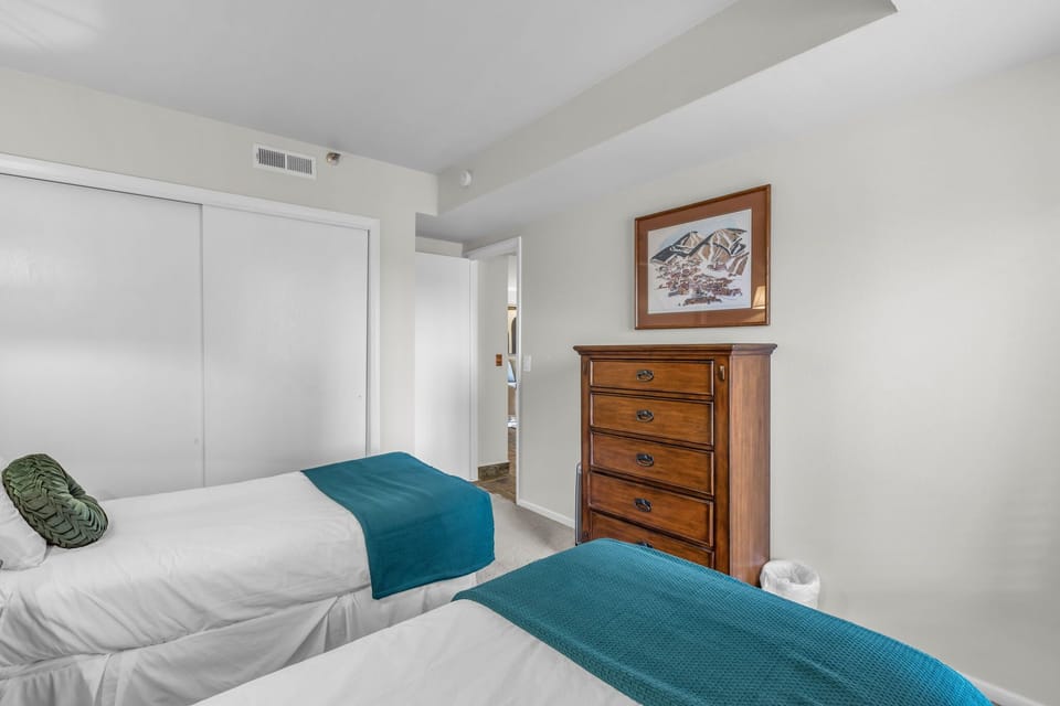 Bedroom 2: 2 twin beds, 28” TV, closet, dresser