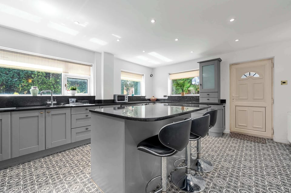 Fully equipped kitchen with breakfast bar seating, everything you need to cook at home