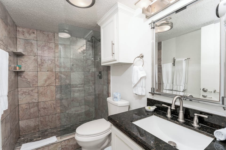 The guest bathroom has a freshly tiled walk-in shower for your family to enjoy after a hot day on the sand!