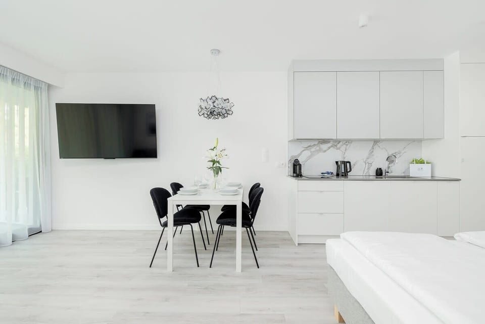 Living room and kitchen with full-size TV
Lounge space with entertainment and stylish dining area.