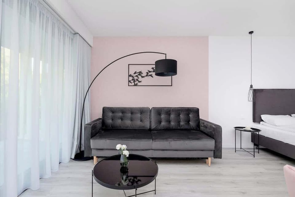 Stylish sitting area with black sofa and glass coffee table
Sophisticated and moody aesthetic with floor-to-ceiling windows.