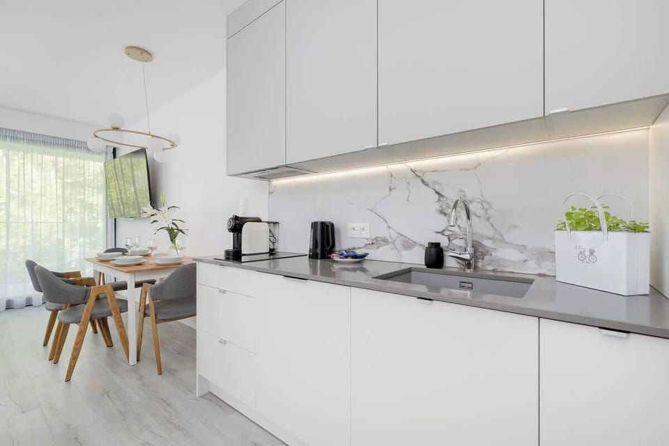 Kitchenette with plenty of kitchen utensils and dishes. 