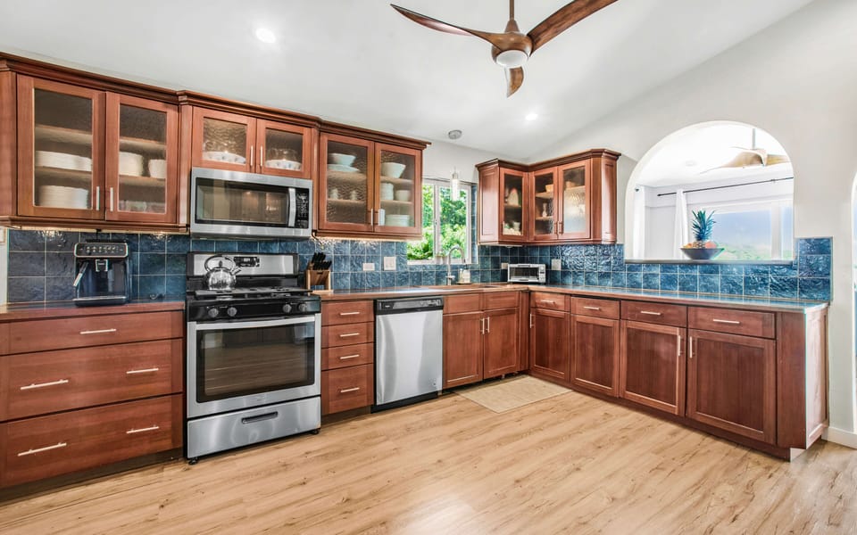 The chef's kitchen has mahogany cabinets, wine cooler, espresso machine & more