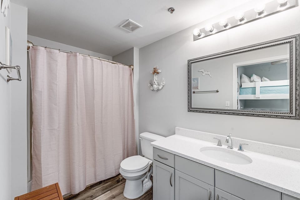 Modern bathroom with a large mirror and shower curtain