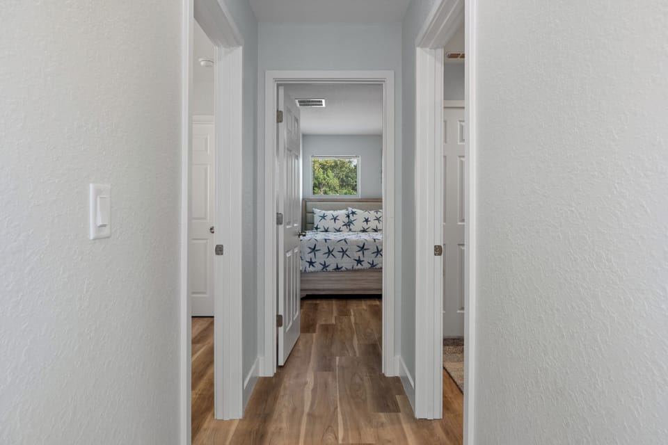 Hallway to both bedrooms and second bathroom