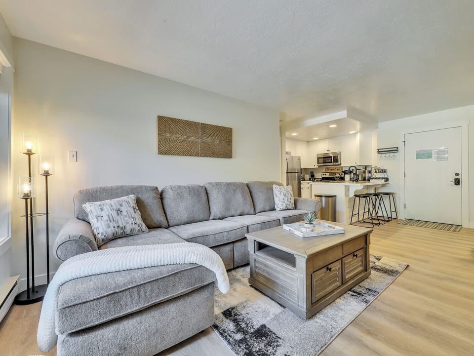 View of the Living Room and Kitchen, Convertible Coffee Table, Counter Seating Area and 3 Stools