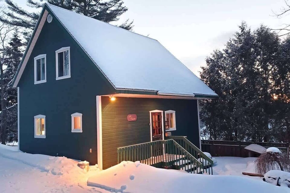 Scenic snowy surroundings outside the house, creating a magical winter wonderland atmosphere.