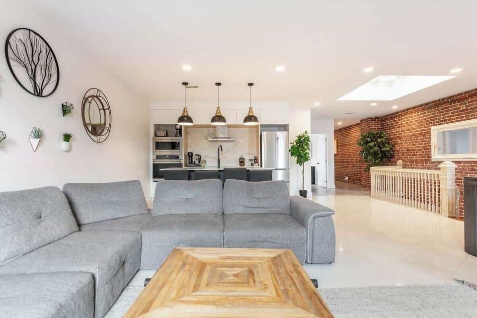 Comfortable grey sofa and wooden table add warmth and style to the living area.