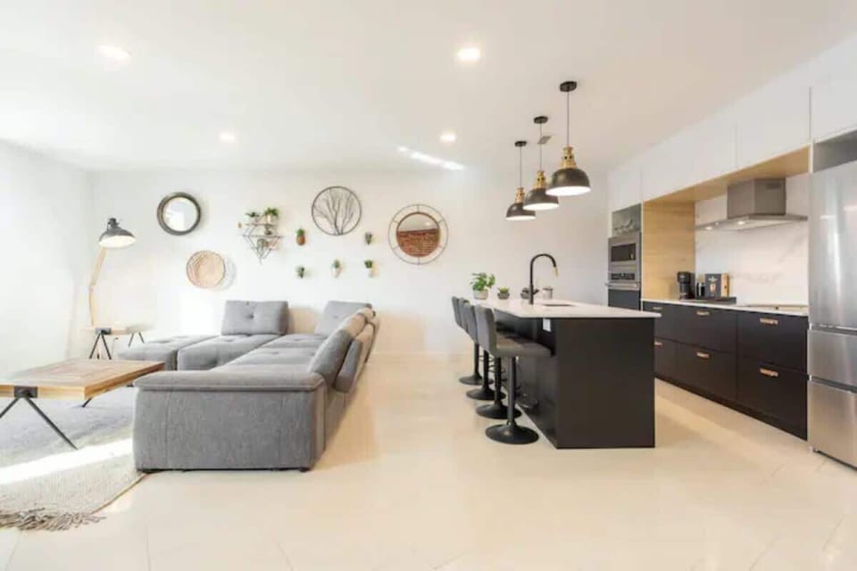 Comfortable living area situated just behind the kitchen countertops, perfect for easy entertaining and relaxation.