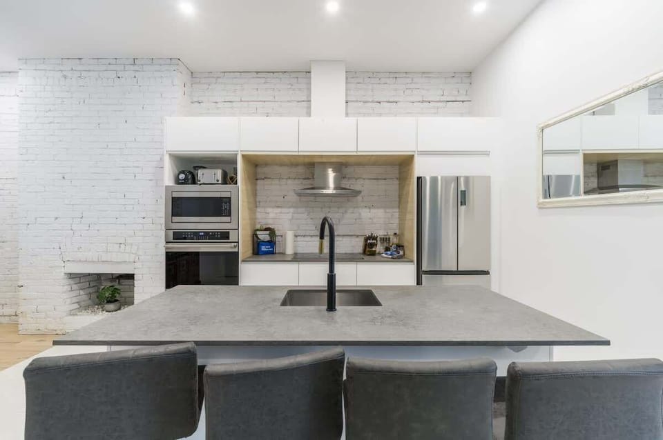 Modern kitchen area featuring a sleek grey and white color scheme for a clean and stylish look.