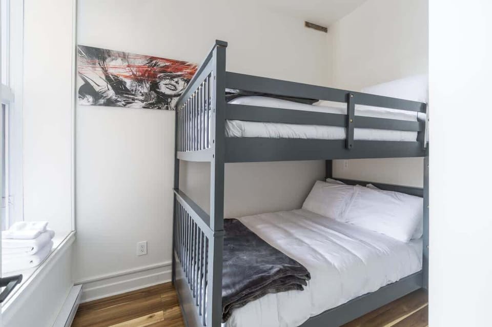 Bright white bedroom featuring a double-deck bunk bed—perfect for families or groups.