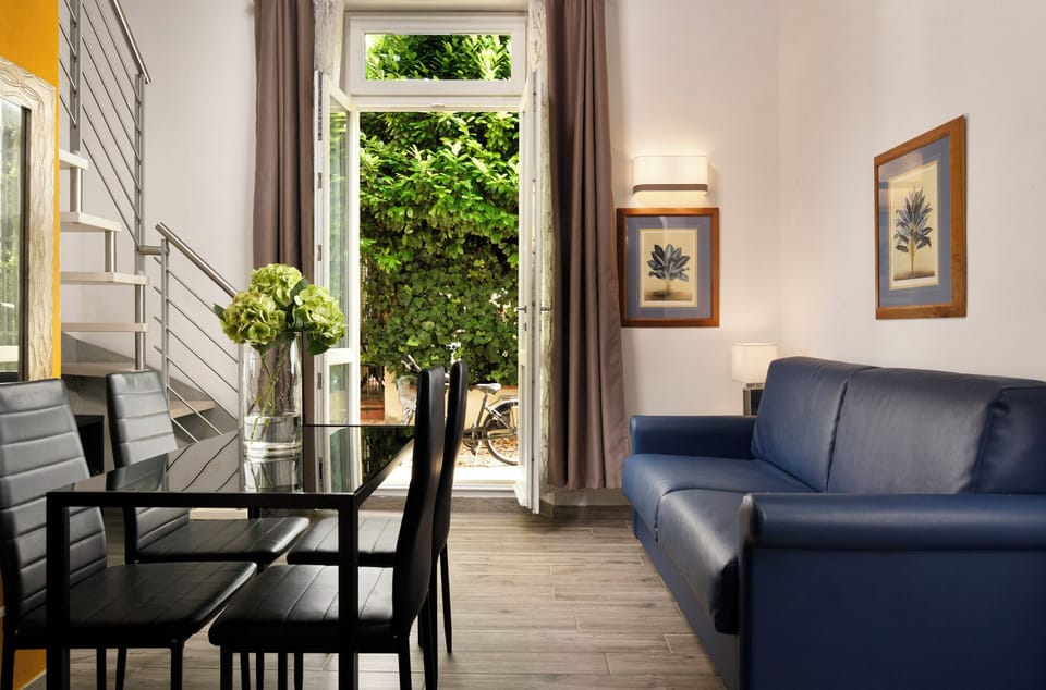 Junior Suite, Garden View | Down comforters, in-room safe, individually decorated, desk