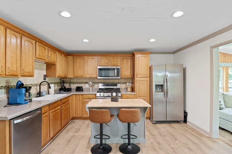 Fully stocked kitchen with island and bar stool seating for two