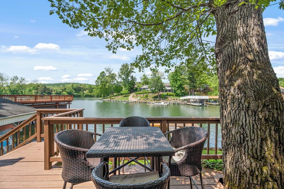 Intimate seating area on the deck, ideal for meals or relaxing by the water.