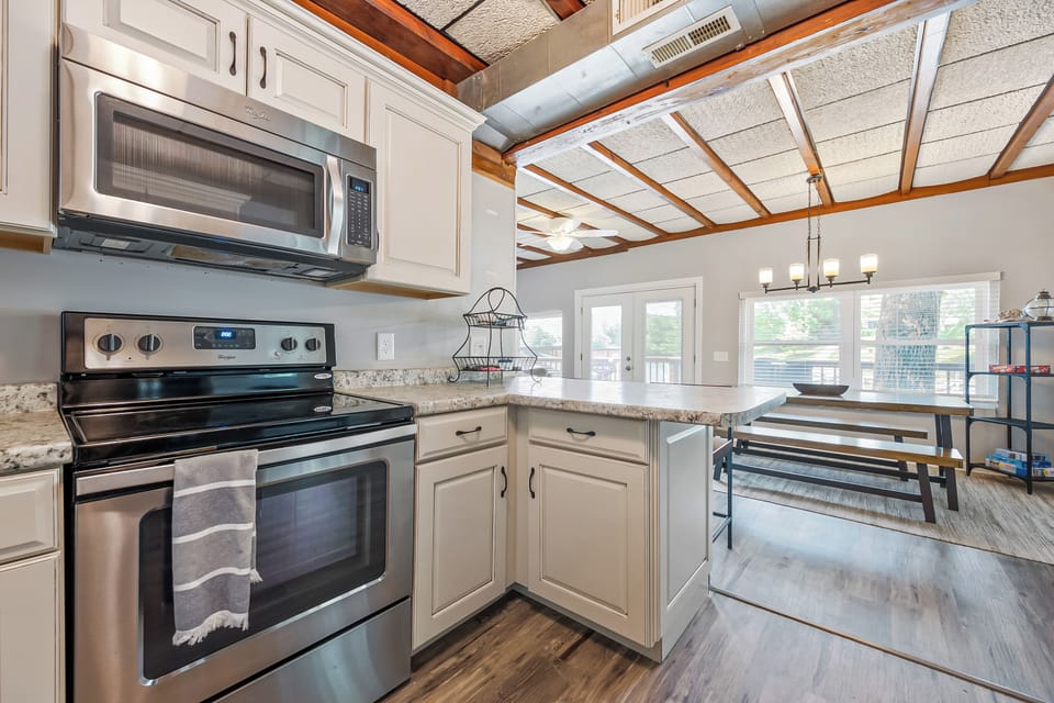 Stainless steel appliances and plenty of counter space, perfect for preparing meals.