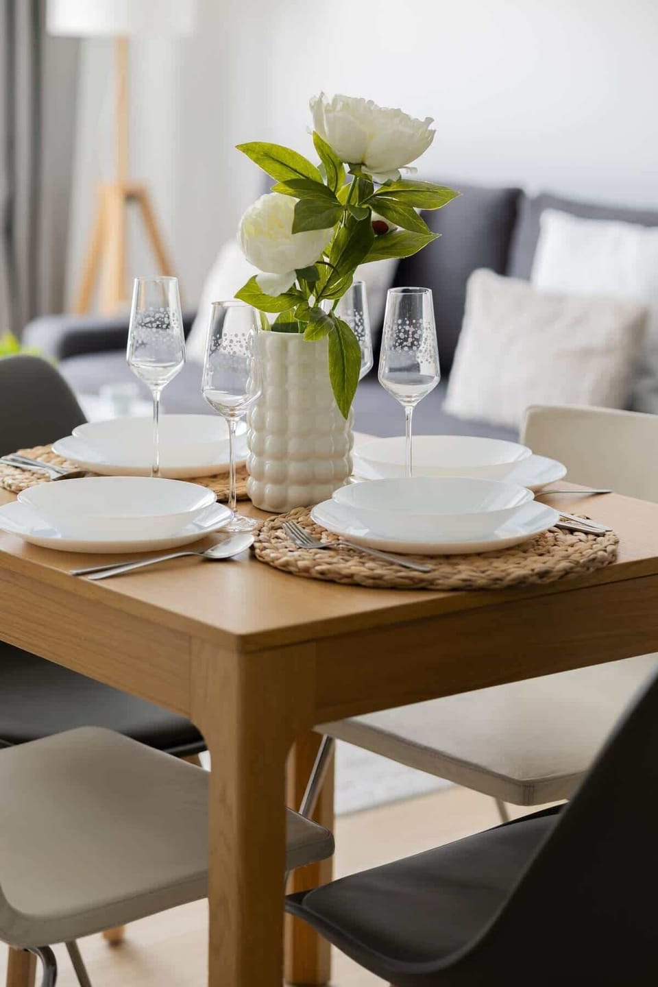 Functional Dining Area – Detail view of the table set up for a meal, with soft lighting and decorative touches.