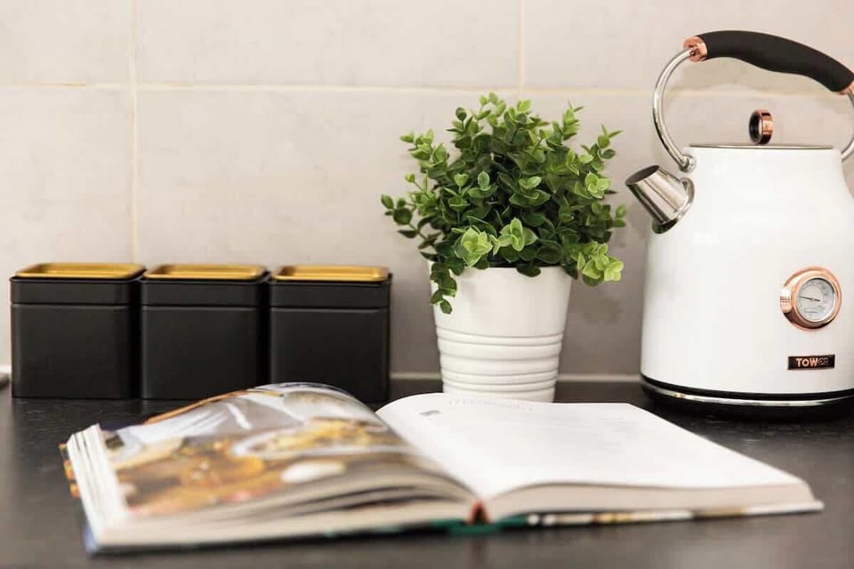 "A small yet sleek and minimalist kitchen, designed for both efficiency and style—perfect for preparing meals in a modern, clutter-free space."