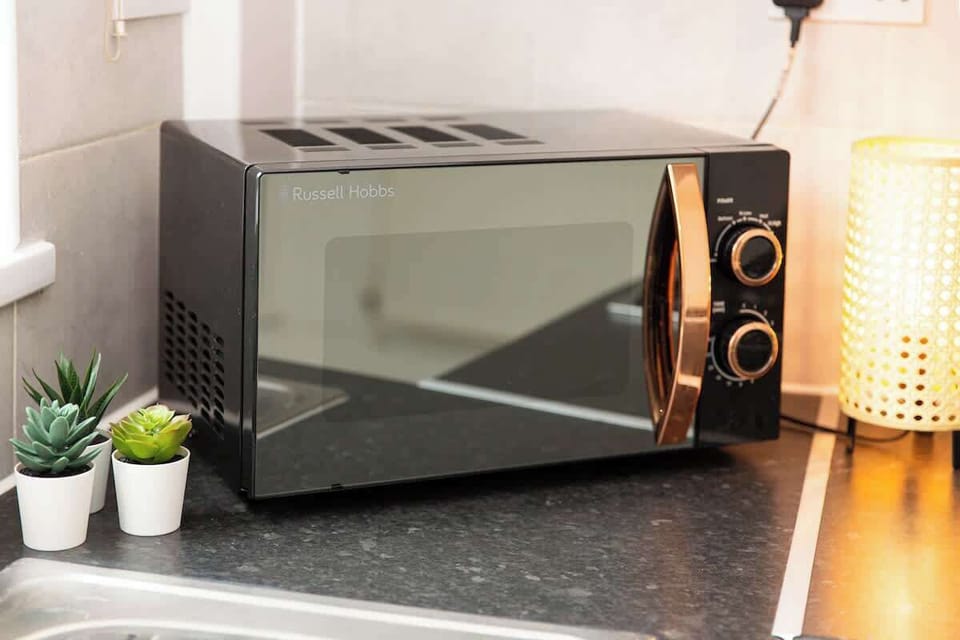 "A small yet sleek and minimalist kitchen, designed for both efficiency and style—perfect for preparing meals in a modern, clutter-free space."