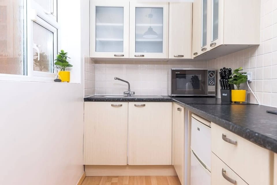 Compact yet complete — a small, spotless kitchen fully equipped with everything you need to cook and dine with ease.