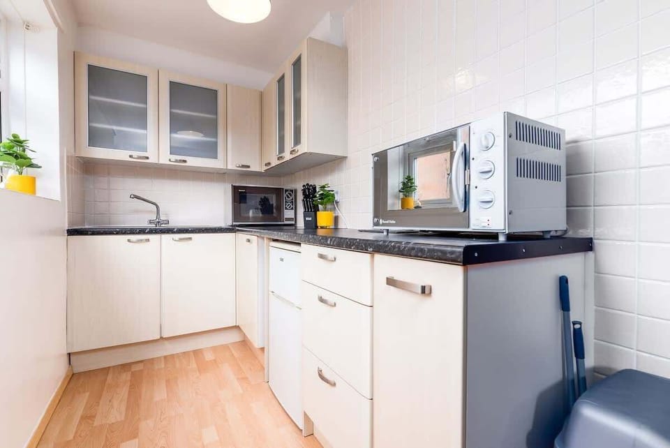 Compact yet complete — a small, spotless kitchen fully equipped with everything you need to cook and dine with ease.